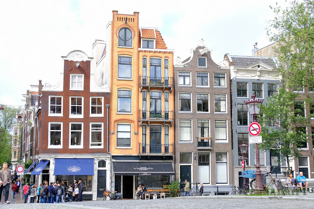  Tall narrow houses line the streets of Amsterdam. See the posts sticking out from the top? Those are for pulley systems used to haul up large items that won't fit up the stairs or through the door.