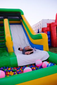 Josh goes down the bouncy slide at The Big Bounce America