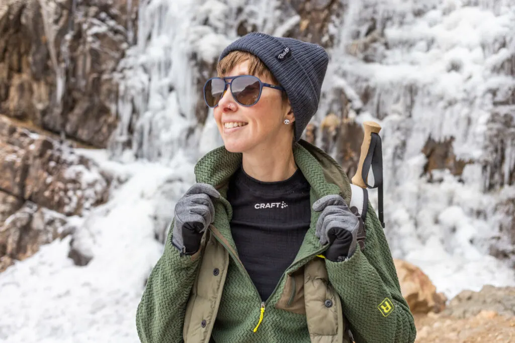 A woman wears a base layer under a zip-up.