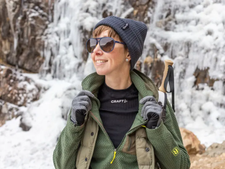 A woman wears a base layer under a zip-up.