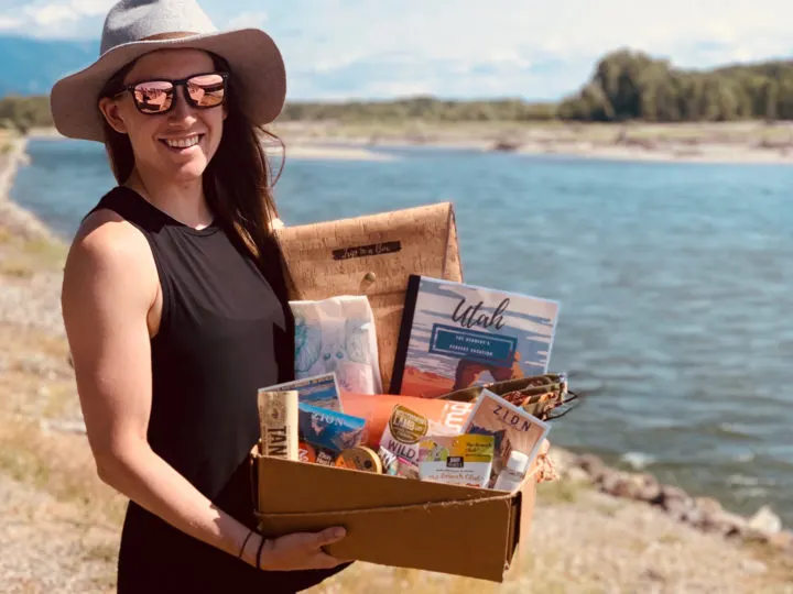 Shelby Dziwulski, founder of Authenteco Travel, with a box of goodies for travel clients.