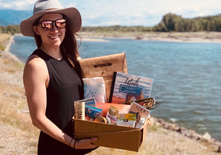 Shelby Dziwulski, founder of Authenteco Travel, with a box of goodies for travel clients.