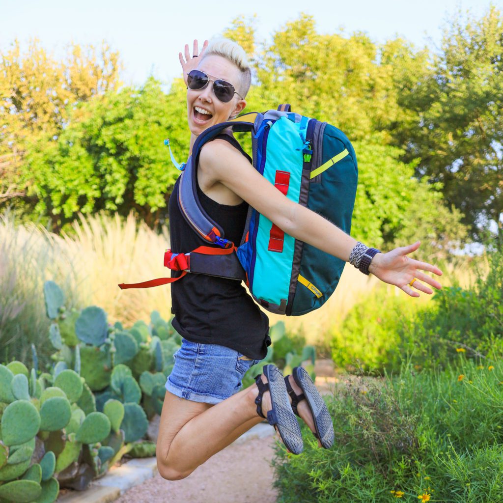 Alisha leaping for joy with the Cotopaxi Allpa 35L Del Dia