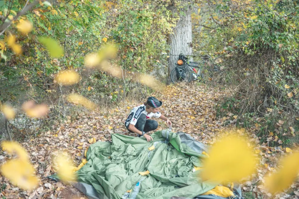 setting up a tent while bikepacking