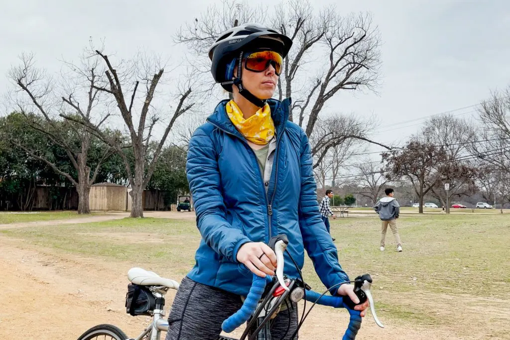 Alisha cycling on the bike path with her Sena R1 Evo Smart Helmet.