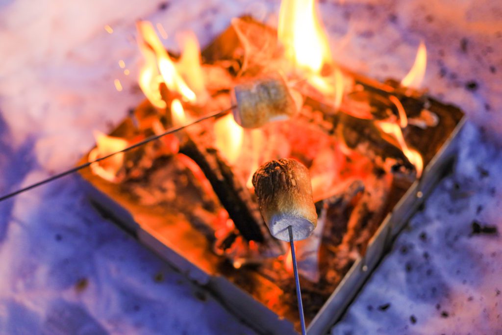 roasting marshmallows over the Wolf and Grizzly Fire Safe portable fire pit.