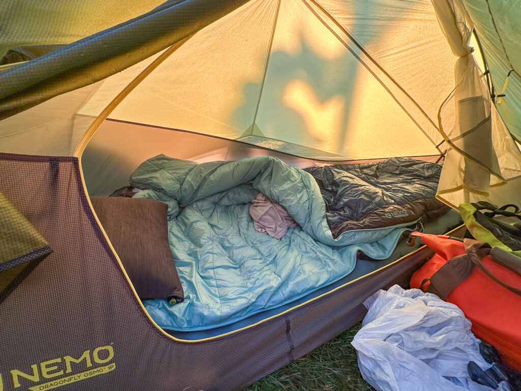 A Nemo sleeping bag, tent, and bunched up bag liner.