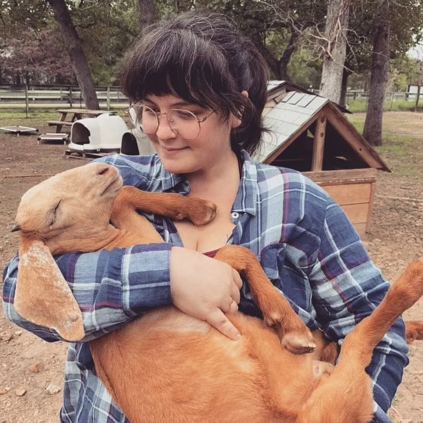 Britty Hamby giving a rescue goat some love.