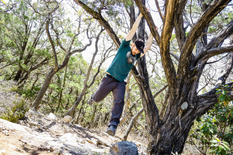 Josh swinging from a tree in prAna ReZion Alameda Pants