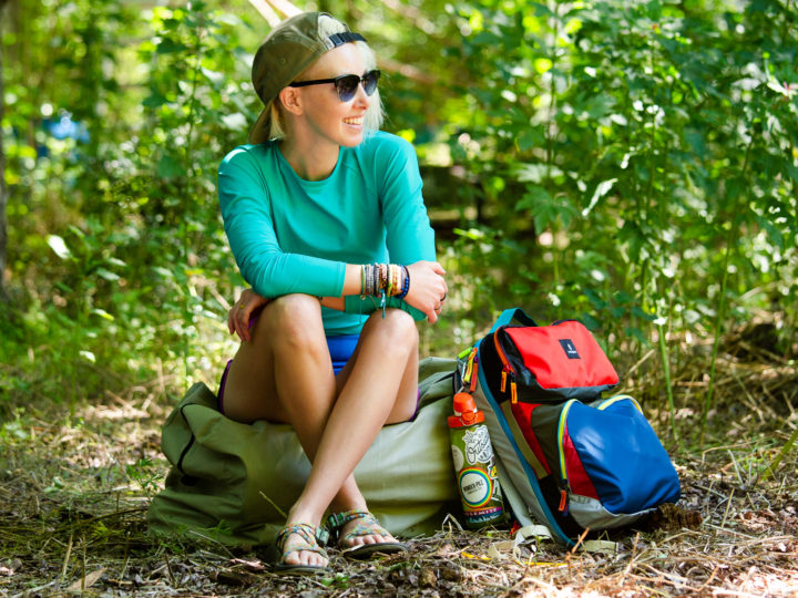 Woman sitting outdoors with a backpack