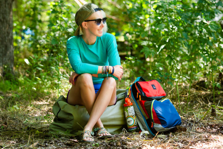 Woman sitting outdoors with a backpack
