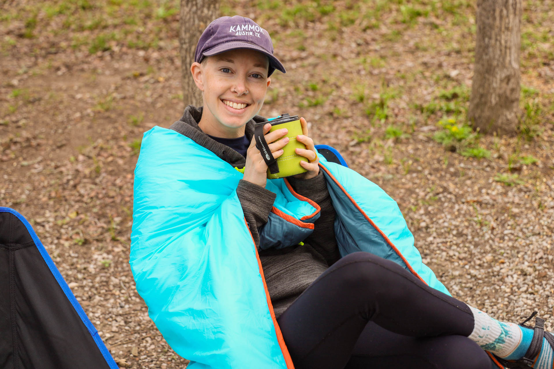 Using the UST Monarch sleeping bag's detachable wings as a shoulder wrap at camp.