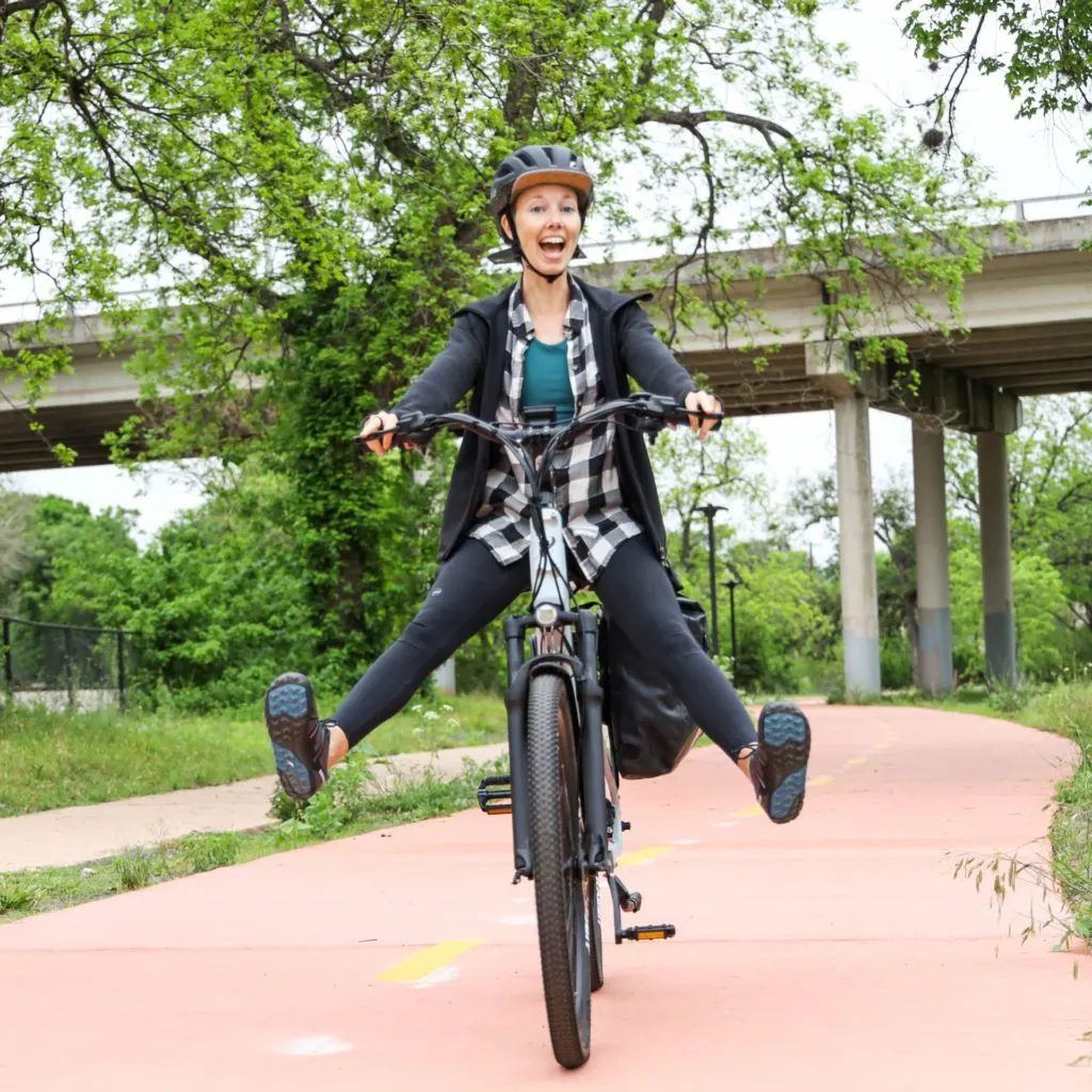 woman joyfully riding an e-bike.