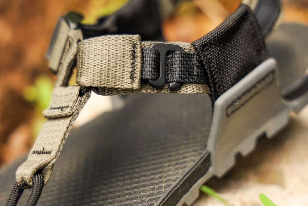 A close up of the G hook and loop system on the side strap of the Bedrock Cairn Pro II Adventure Sandals.