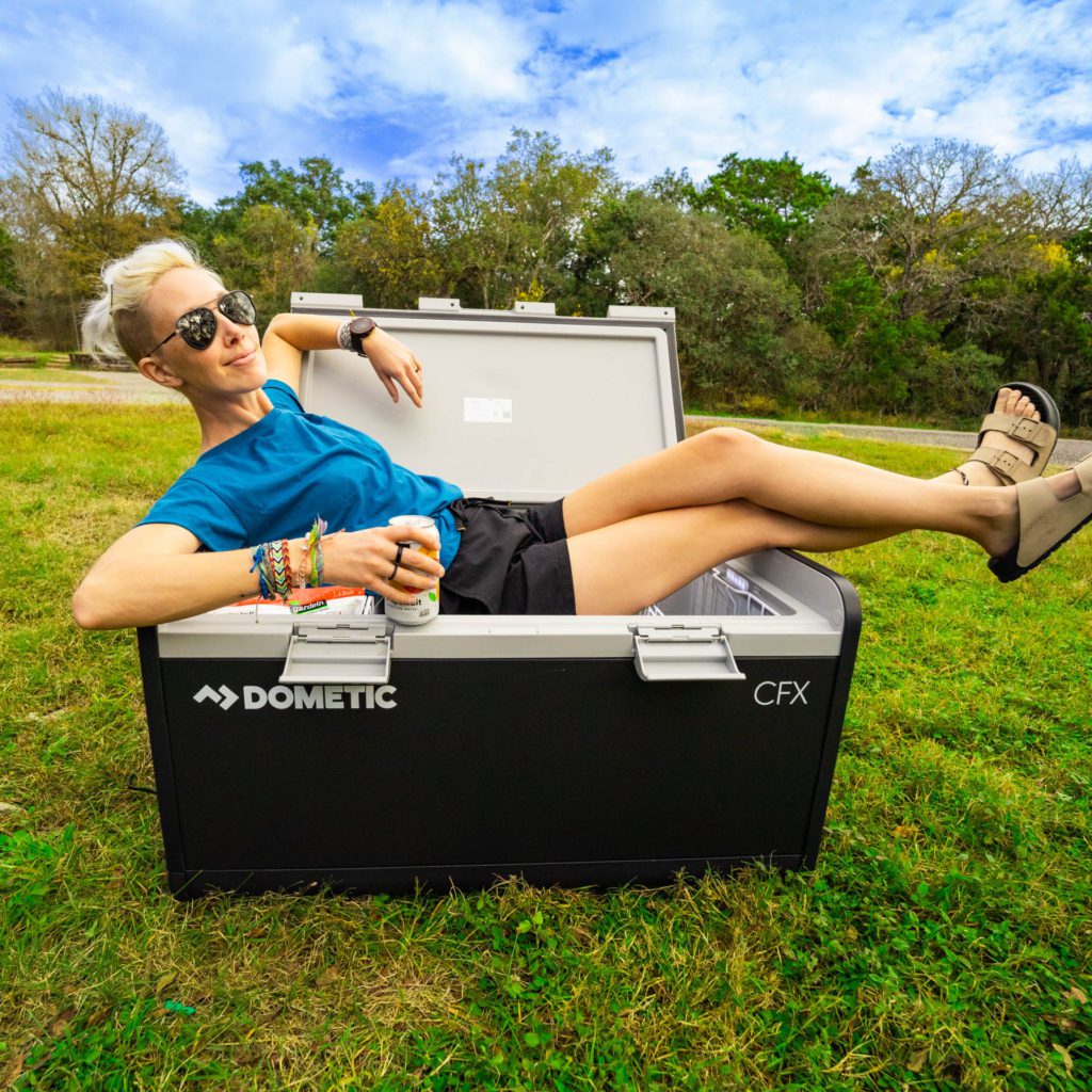 Woman sitting in a Dometic cooler.