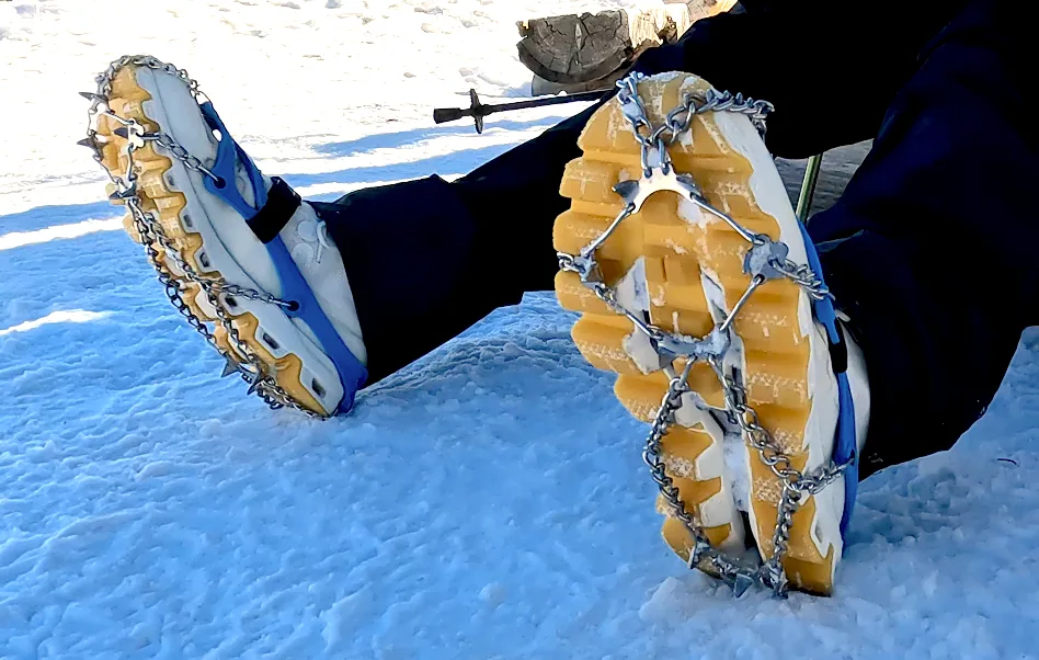 Hiking spikes: Veriga microspikes over hiking boots in the snow.