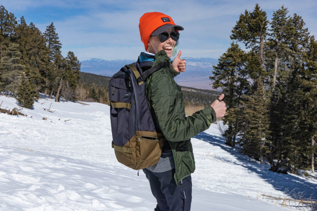 A woman wearing a Pak-Jak jacket with the backless setup and a day pack.