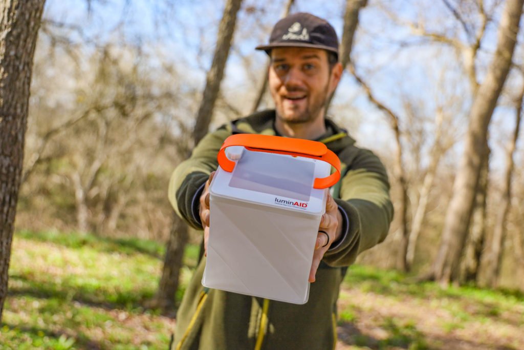 man holding a LuminAID solar camp lantern