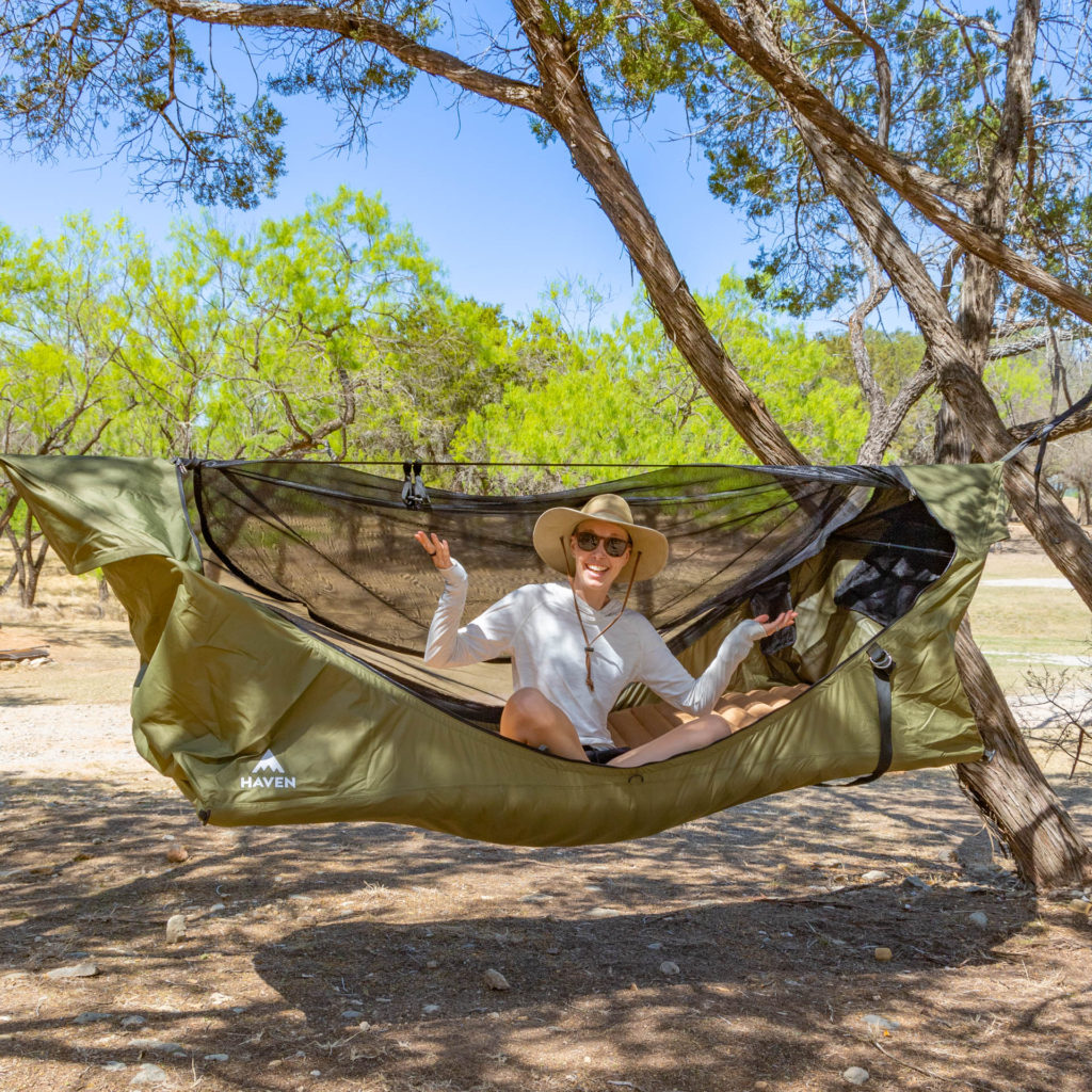 A woman sitting up cross-legged in the Haven Safari.