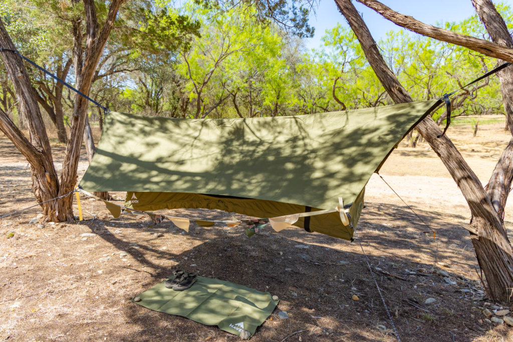 The Haven Safari lay-flat hammock with rain fly, bunting banner, and welcome mat.