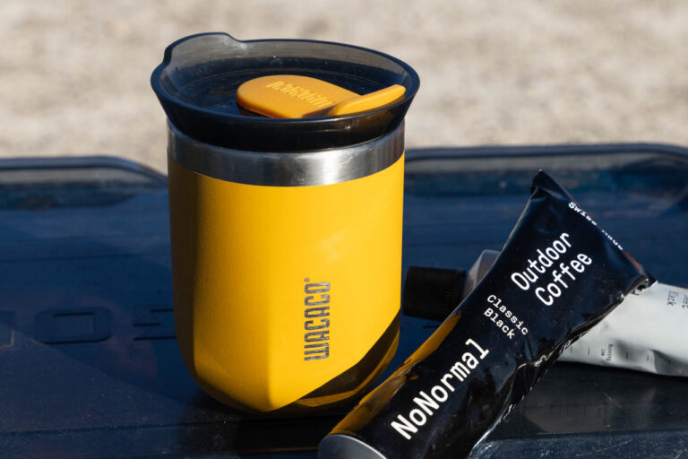 The Wacaco Octaroma travel mug next to No Normal coffee.