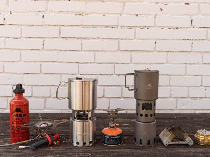 backpacking stoves lined up in a row.
