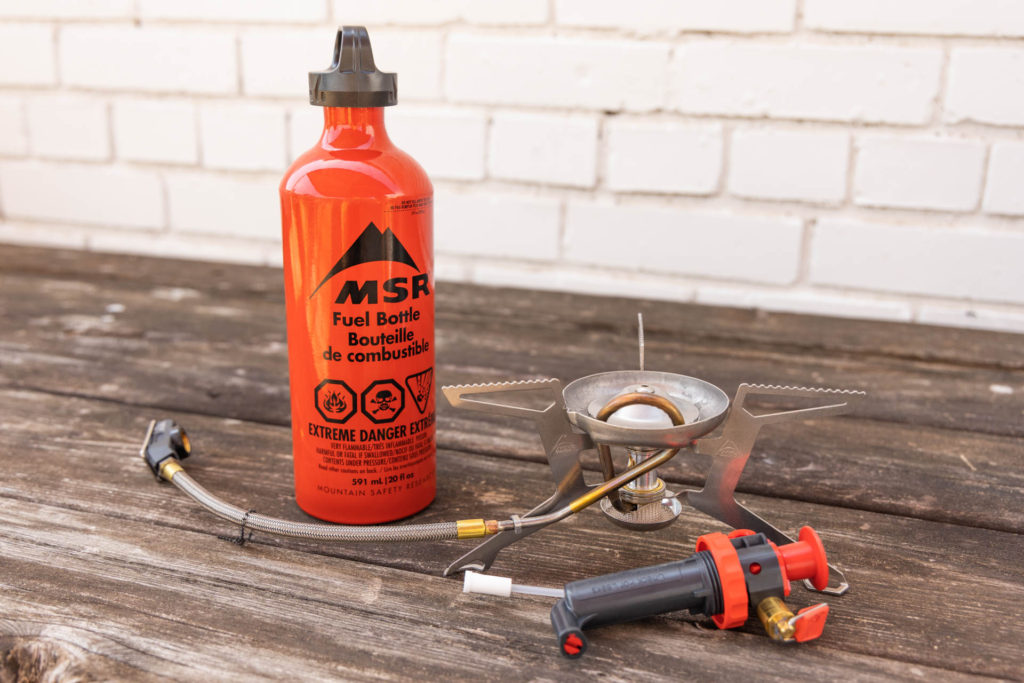 An MSR Whisperlite Universal liquid fuel stove with a bottle of white gas.