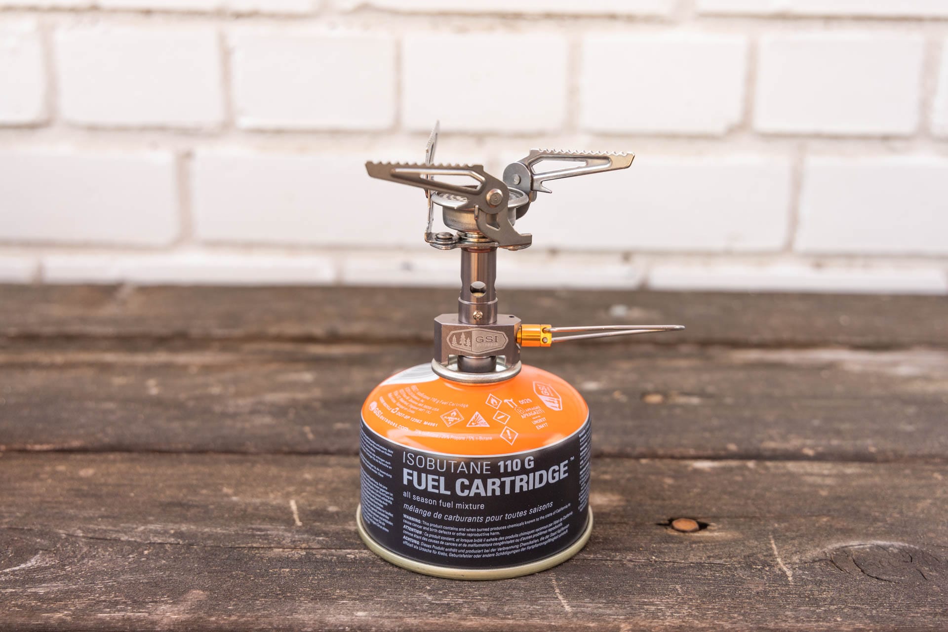 A backpacking stove connected to a fuel canister.