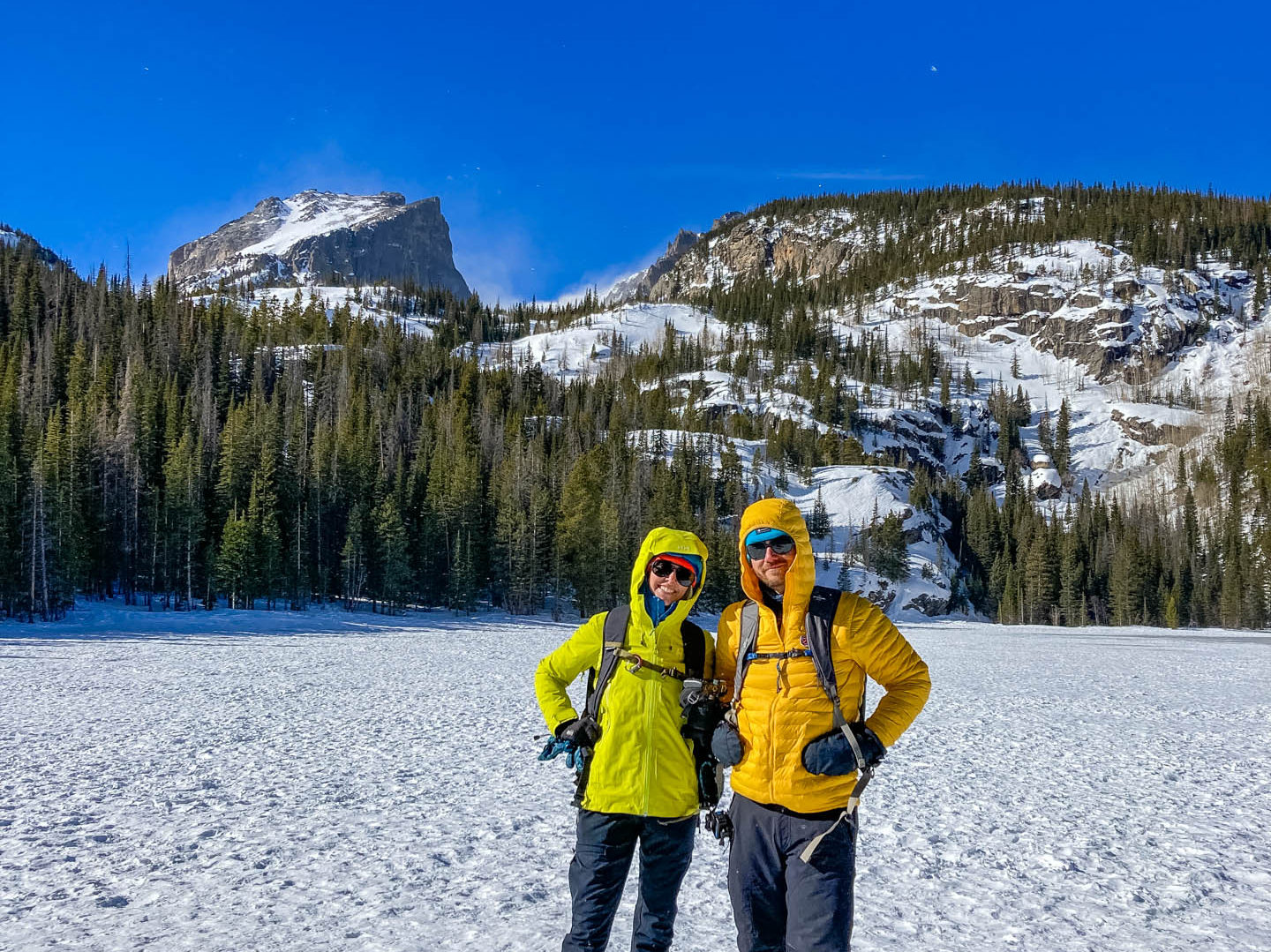 Couple posing on frozen Bear Lake at Rocky Mountain National Park.
