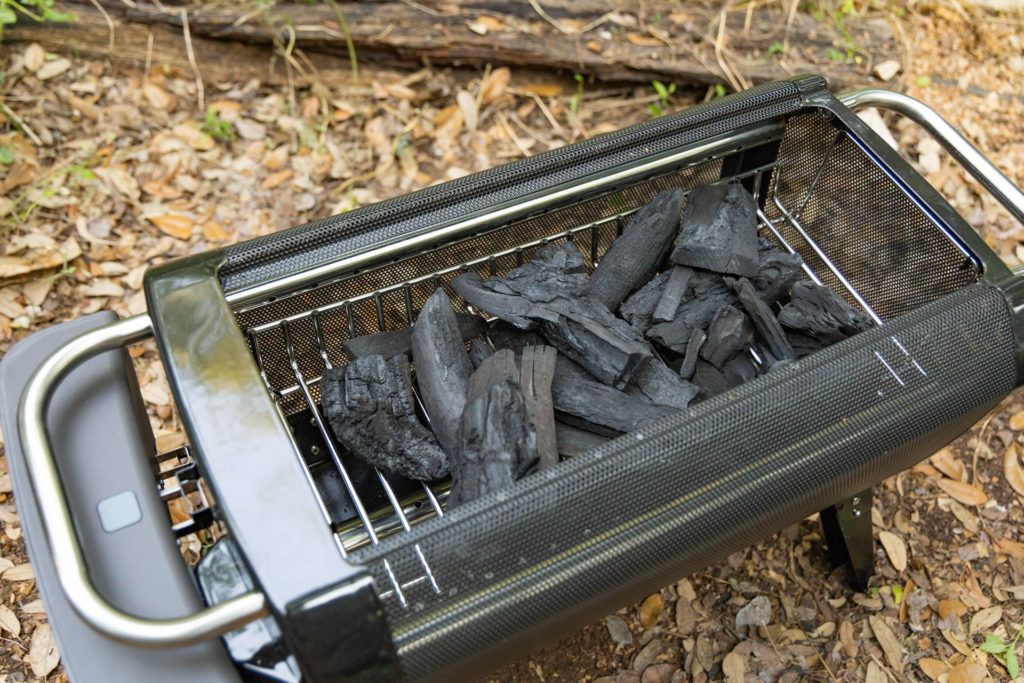 The raised fuel rack loaded with charcoal in the BioLite FirePit+ smokeless fire pit.