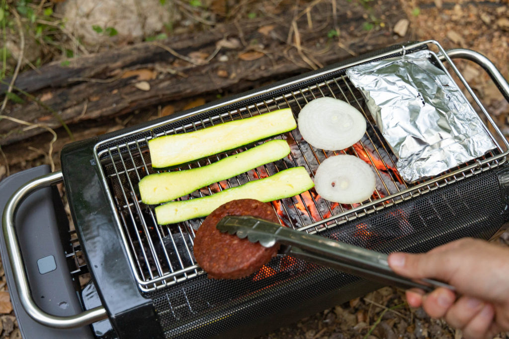 Grilling vegetables and veggie burgers on the BioLite FirePit+ smokeless fire pit.