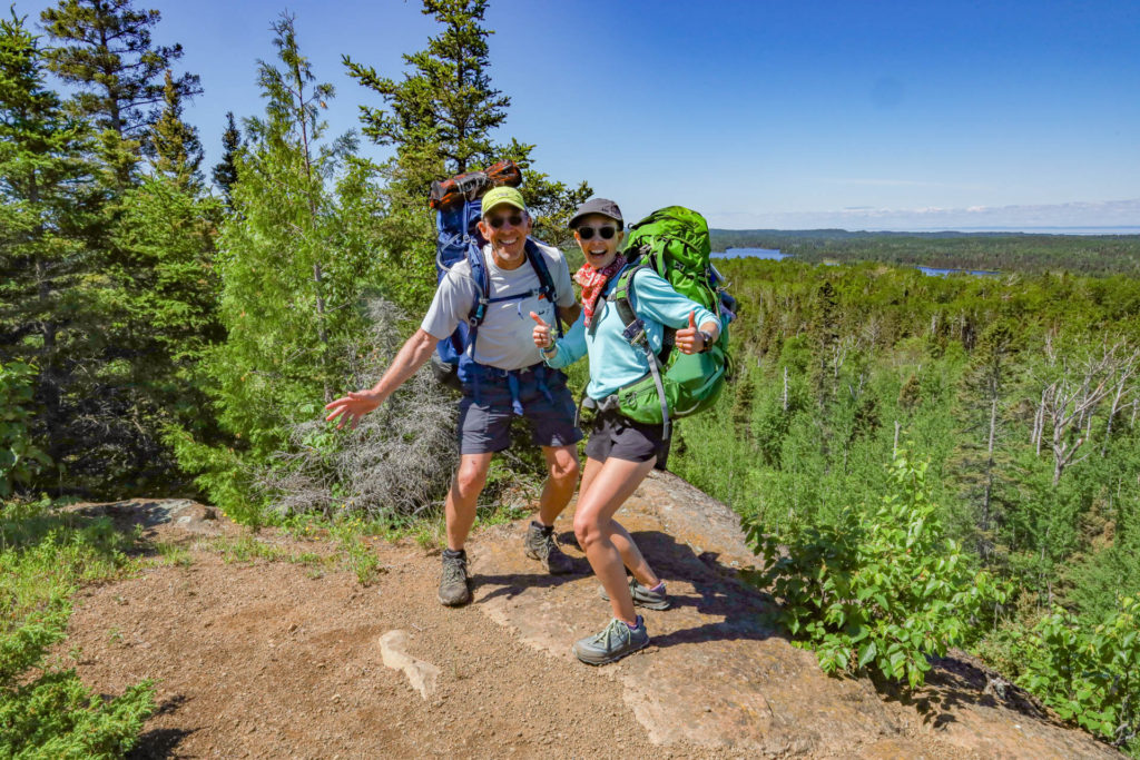 Father's Day: A father and daughter backpacking in Isle Royale National Park, standing at a lookout point looking excited.