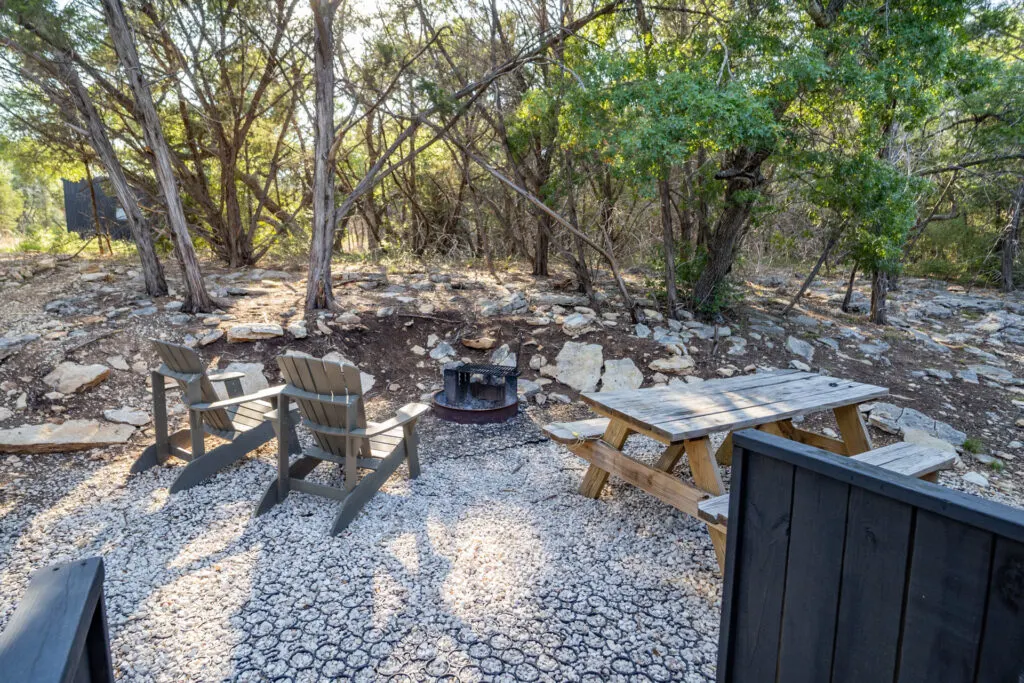 The picnic table and fire pit at the Getaway tiny cabin.