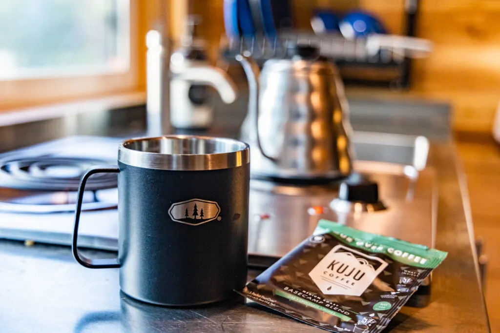 Mug, coffee, and a tea kettle at the Getaway tiny cabin.