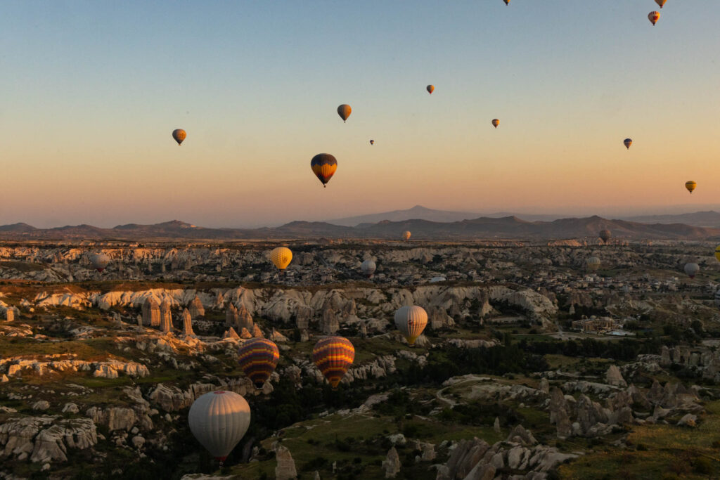 Hot air balloons take to the sky at sunrise in Cappadocia, Turkey