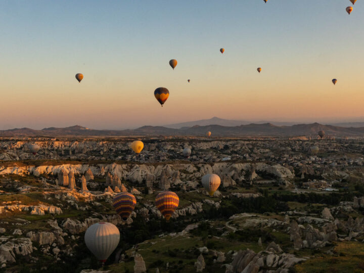 hot air balloons in the air at sunrise in Cappadocia, Turkey.