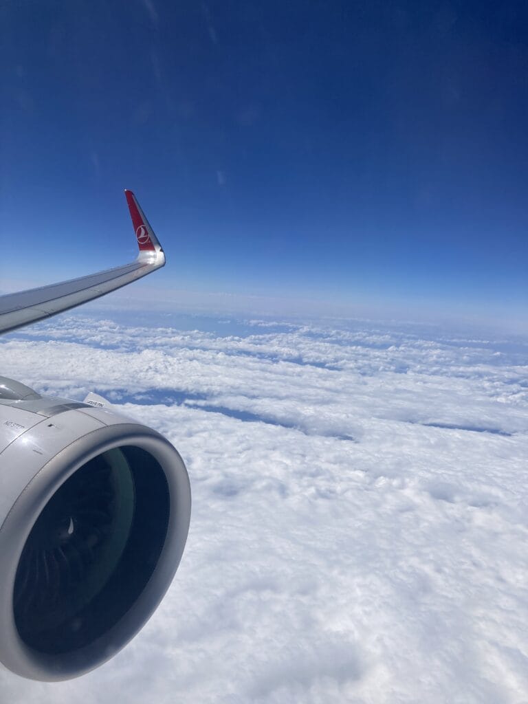 view out an airplane window above the clouds.