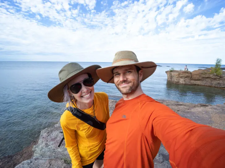 what to do in Marquette, Michigan: a couple stands in front of Lake Superior at Presque Isle Park.