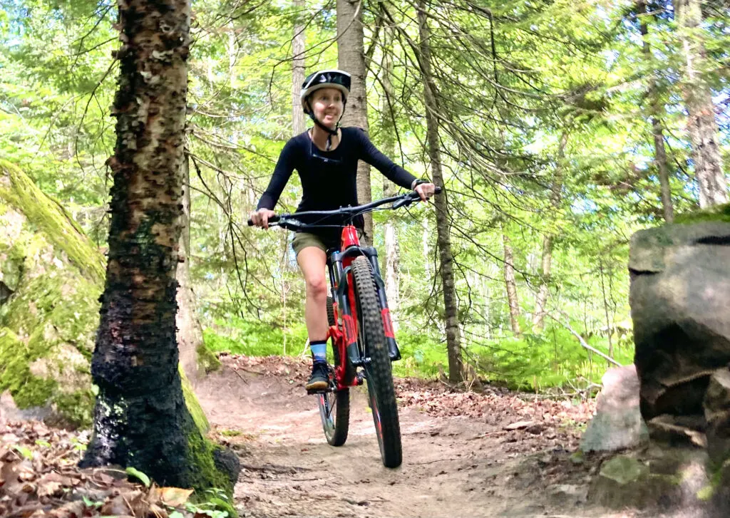 A woman Mountain biking on Marquette's North Trails.