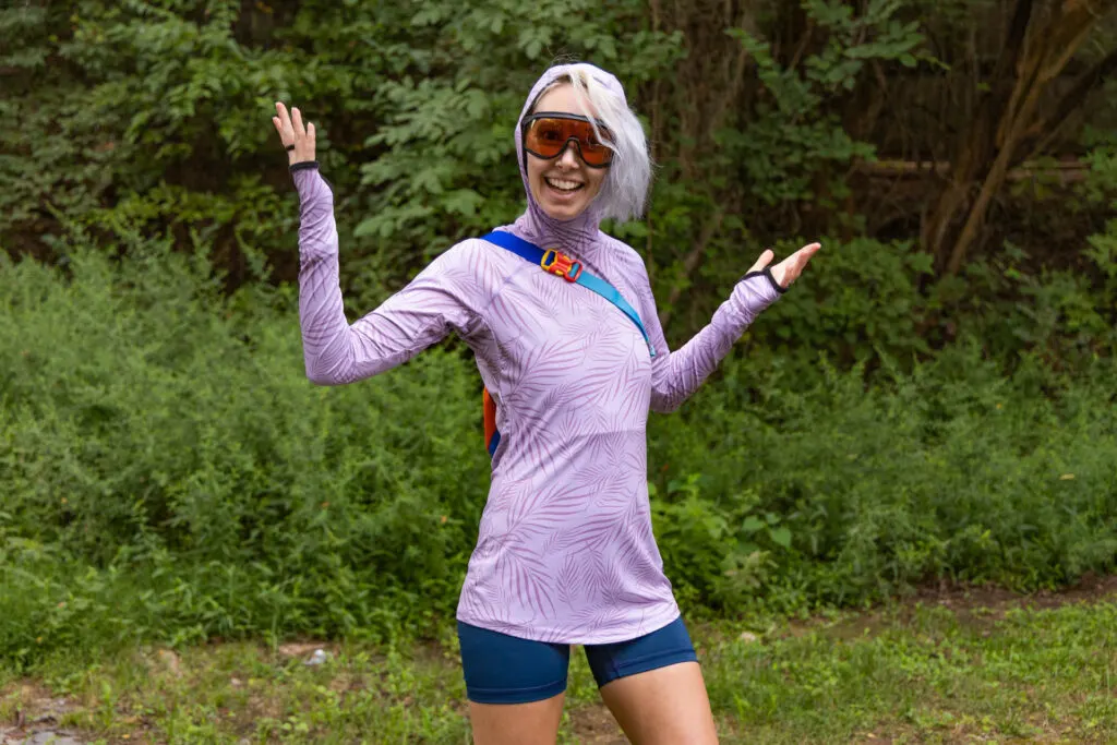 A woman wears The Blackstrap Brackish sun shirt outside.