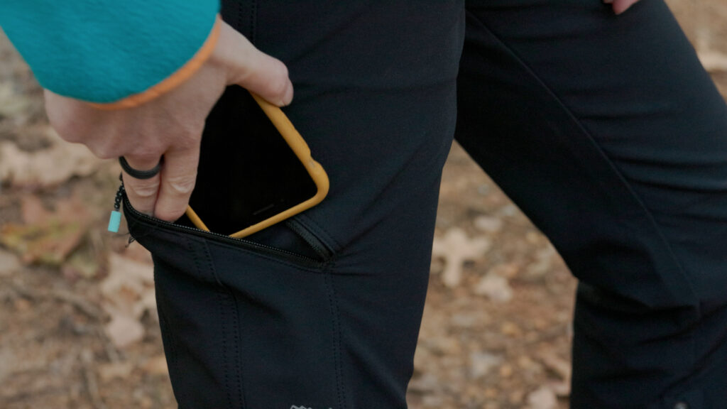 A zipper pocket on the thigh fits most cell phones.