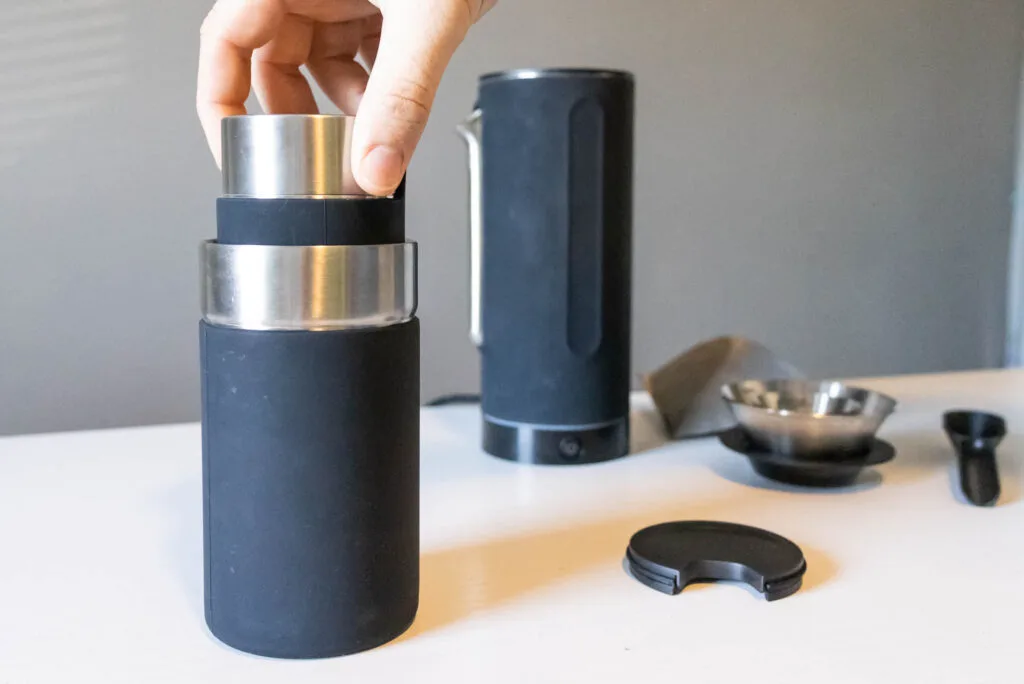 The Pakt coffee canister nestles into the travel mug.