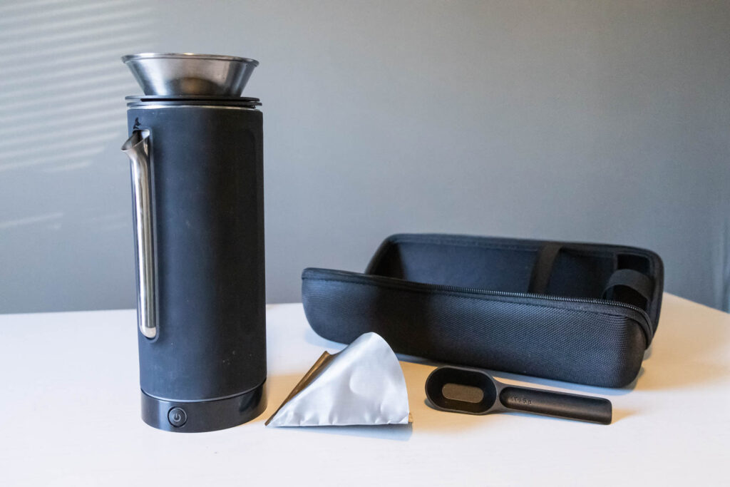 The Pakt Coffee Kit with coffee canister and travel mug nestled inside the kettle and drip filter collapsed on top.