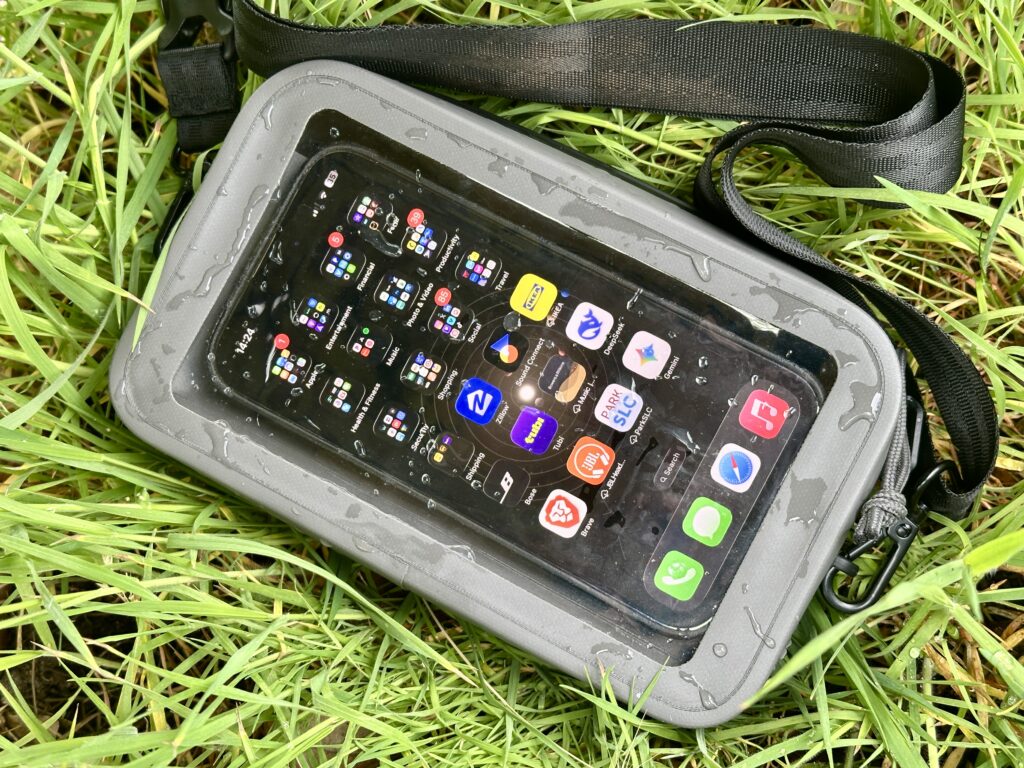The Nite Ize RunOff Waterproof Hip Pack with a phone showing through the clear pocket.