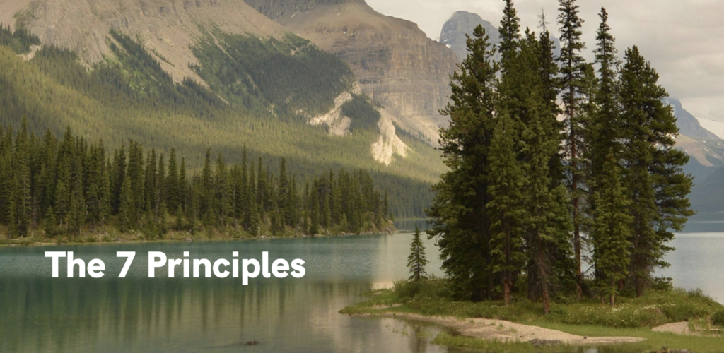 "The Seven Principles" over a lake surrounded by pine trees. Photo from LNT.org.