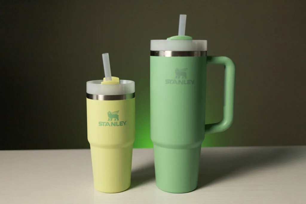 A large white nonrecyclable to-go drink cup with a plastic lid and straw on  a