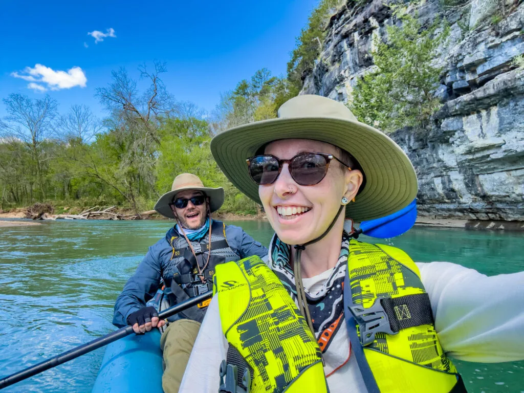 Two smiling kayakers paddling the Buffalo River.