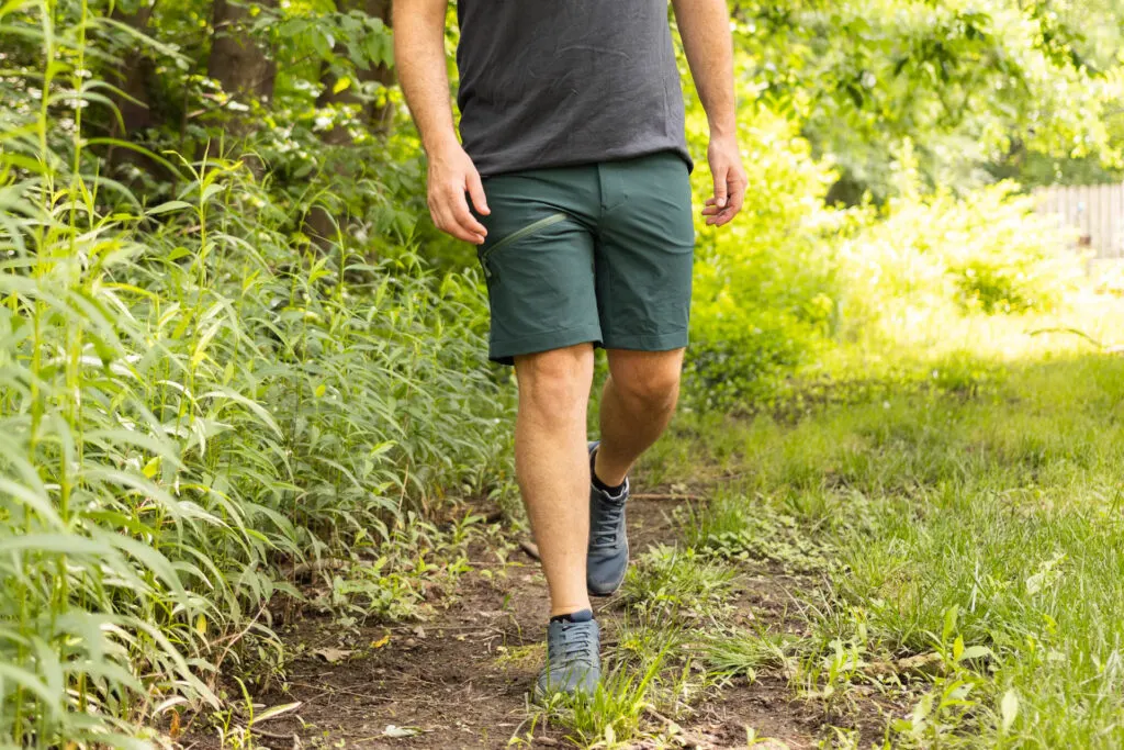 A man's lower half wearing Helly Hansen Blaze Softshell hiking shorts.
