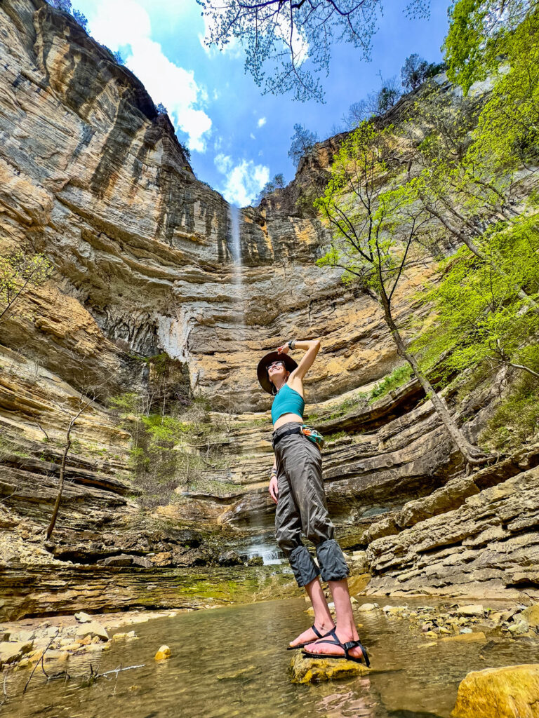 A woman poses in front of Hemmed in Hollow Falls in Buffalo National River park.