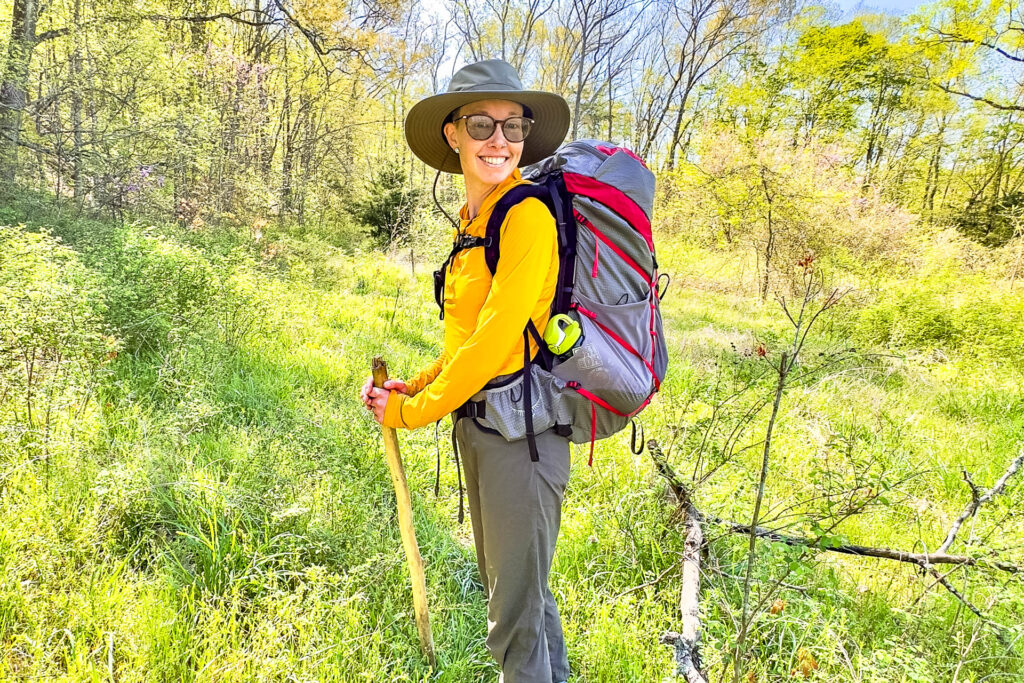 A woman wearing the Osprey Eja Pro 55L backpack.